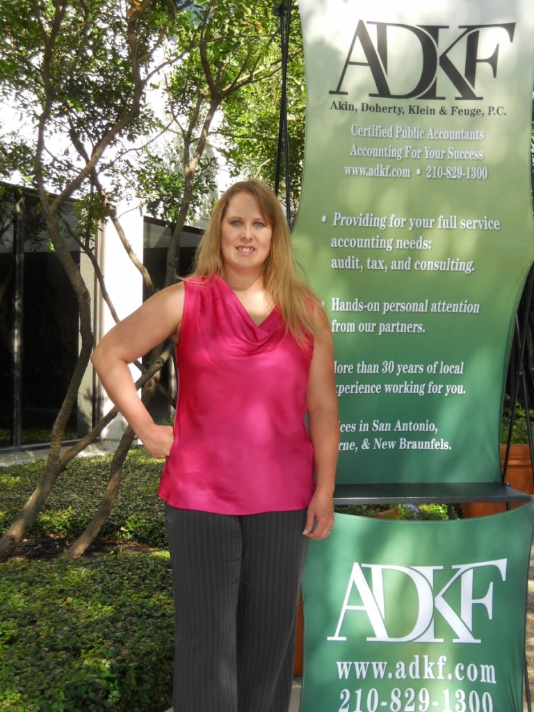 Woman posing near ADKF sign.