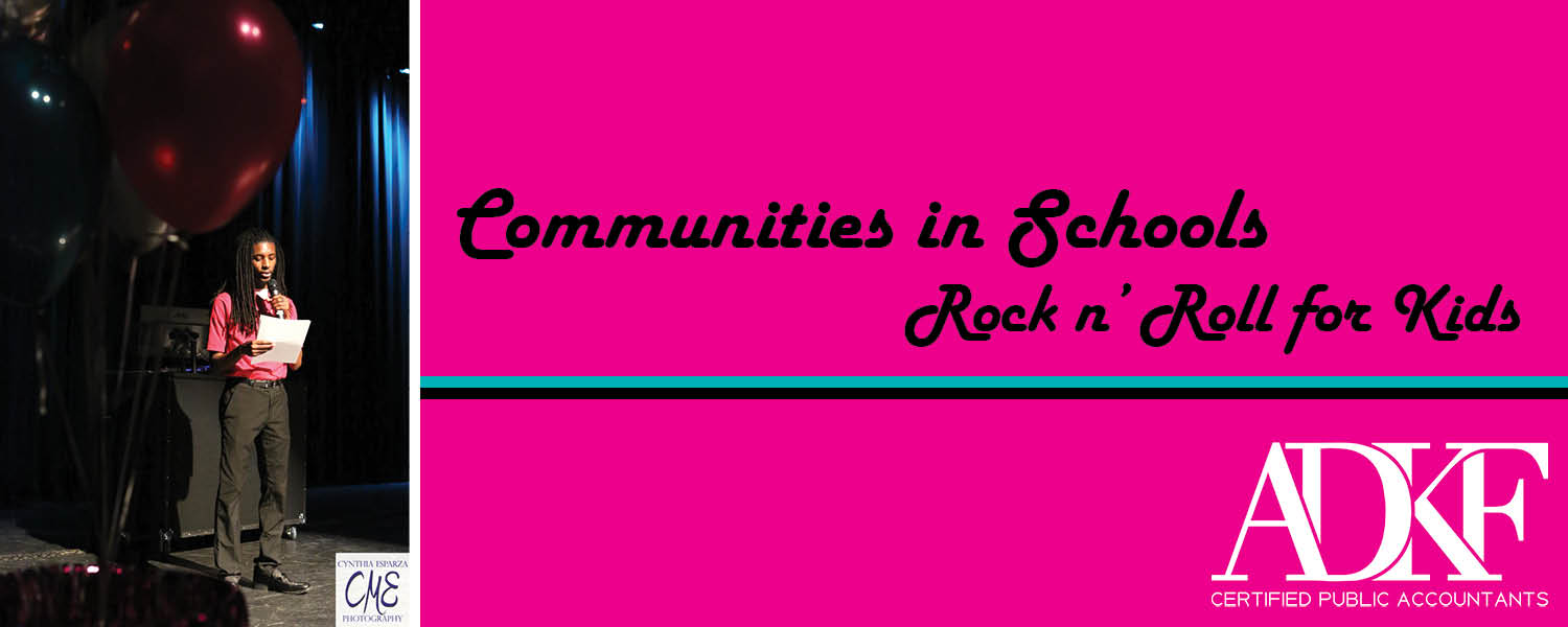 Event stage with balloons and speaker.