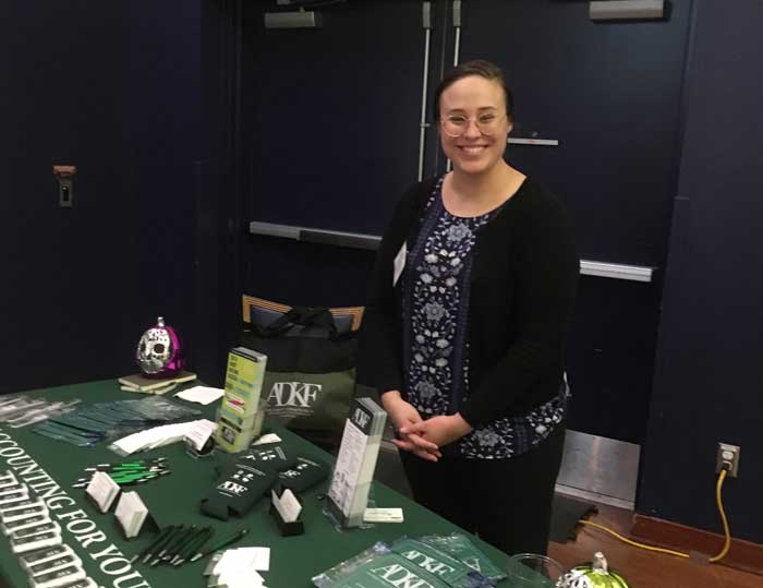 Person at a promotional table.