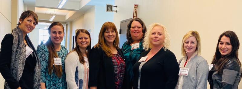 Group of women in hallway together.