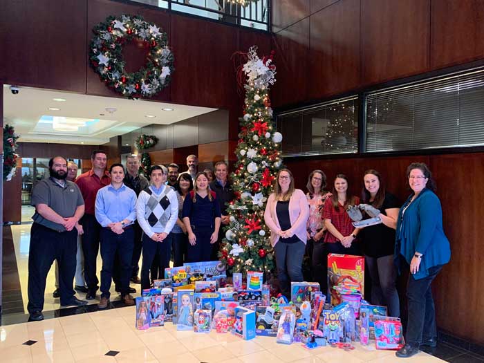 Group photo with holiday decorations and toys.