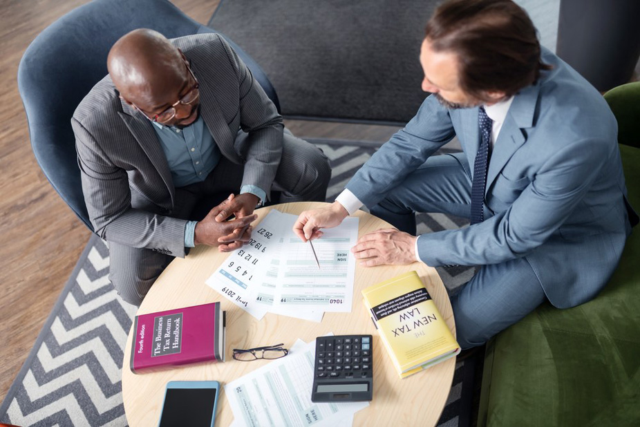 Two professionals discussing tax documents.