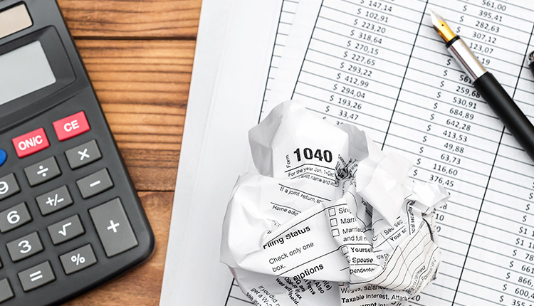 Tax documents and calculator on table