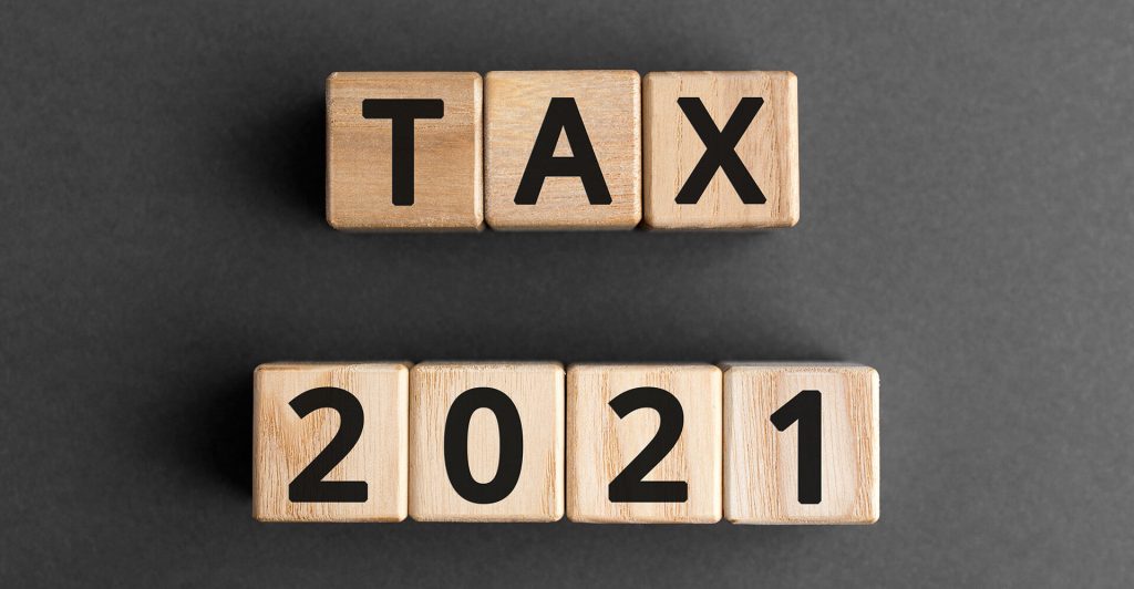 Wooden blocks spelling 'TAX 2021'