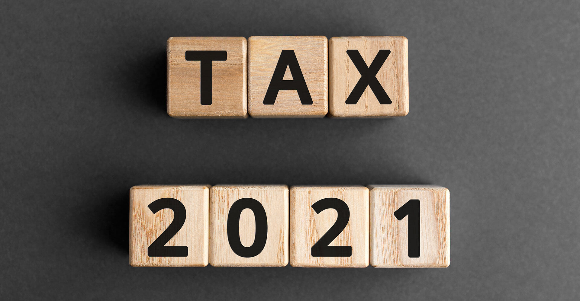 Wooden blocks spelling 'TAX 2021'