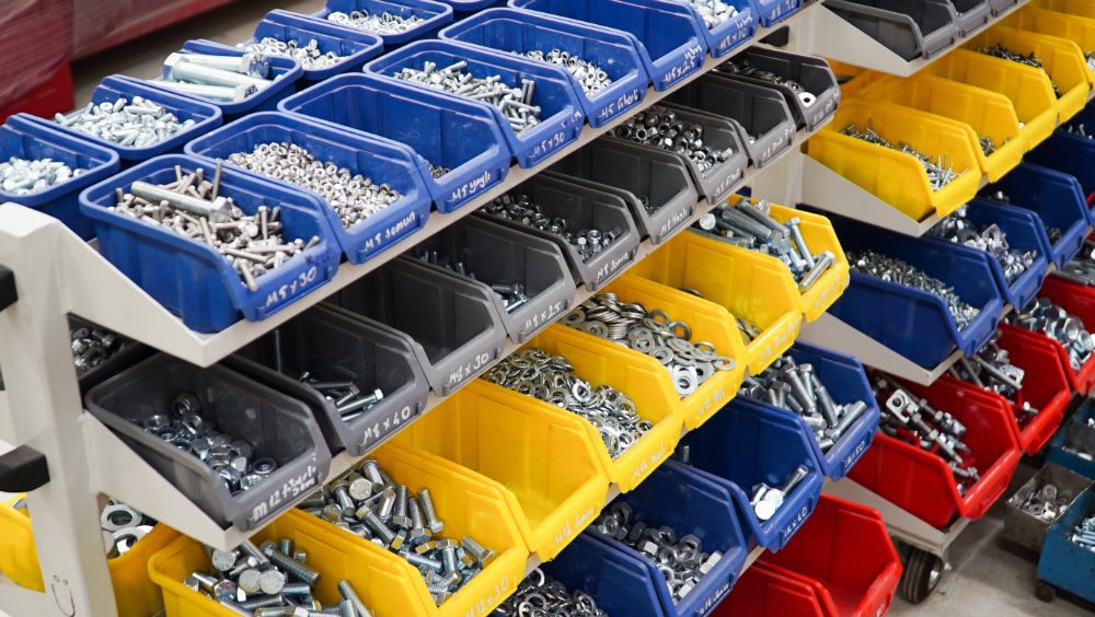 Colorful bins filled with hardware items.