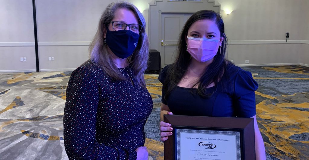 Two women holding a certificate.