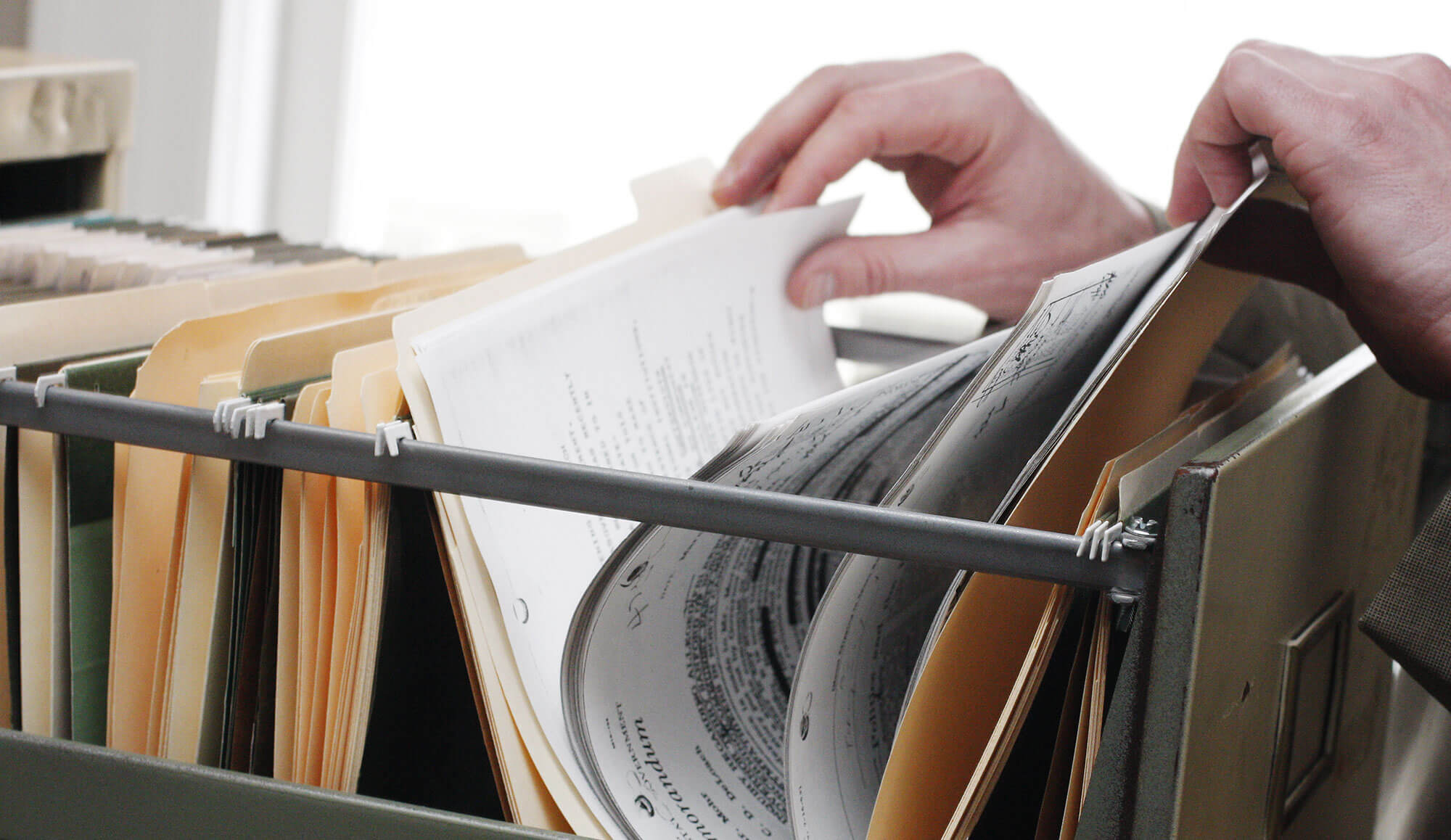 Person sorting through file cabinet
