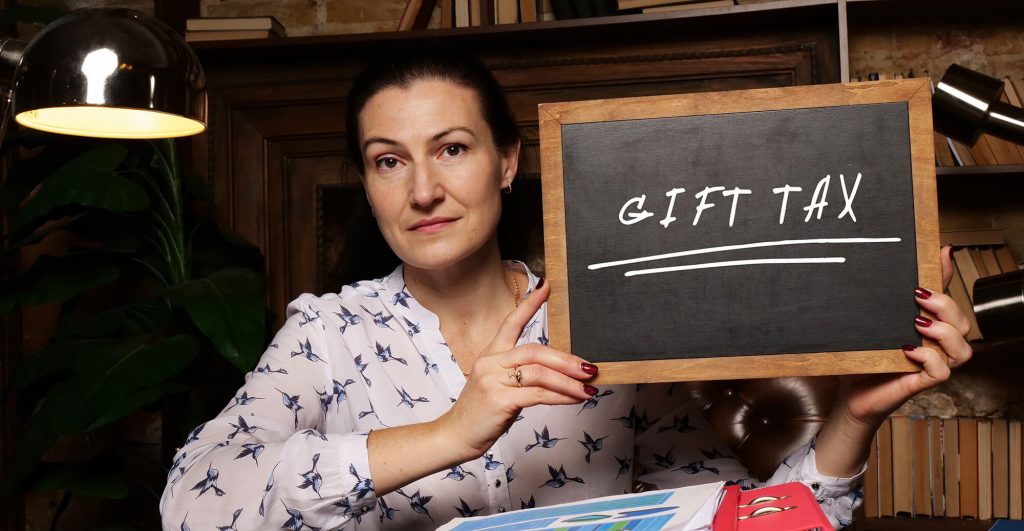 Person holding a chalkboard sign.