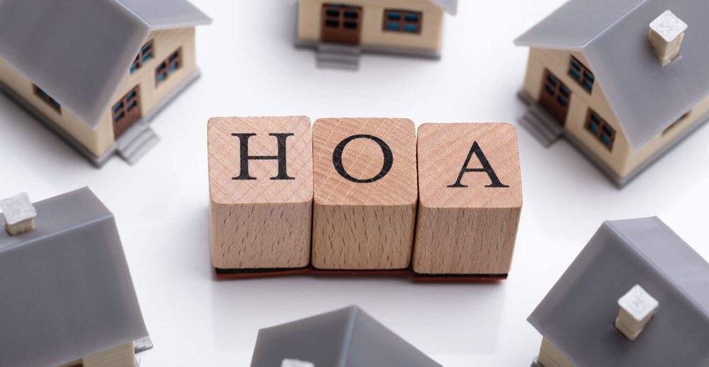 Wooden blocks spelling HOA with houses