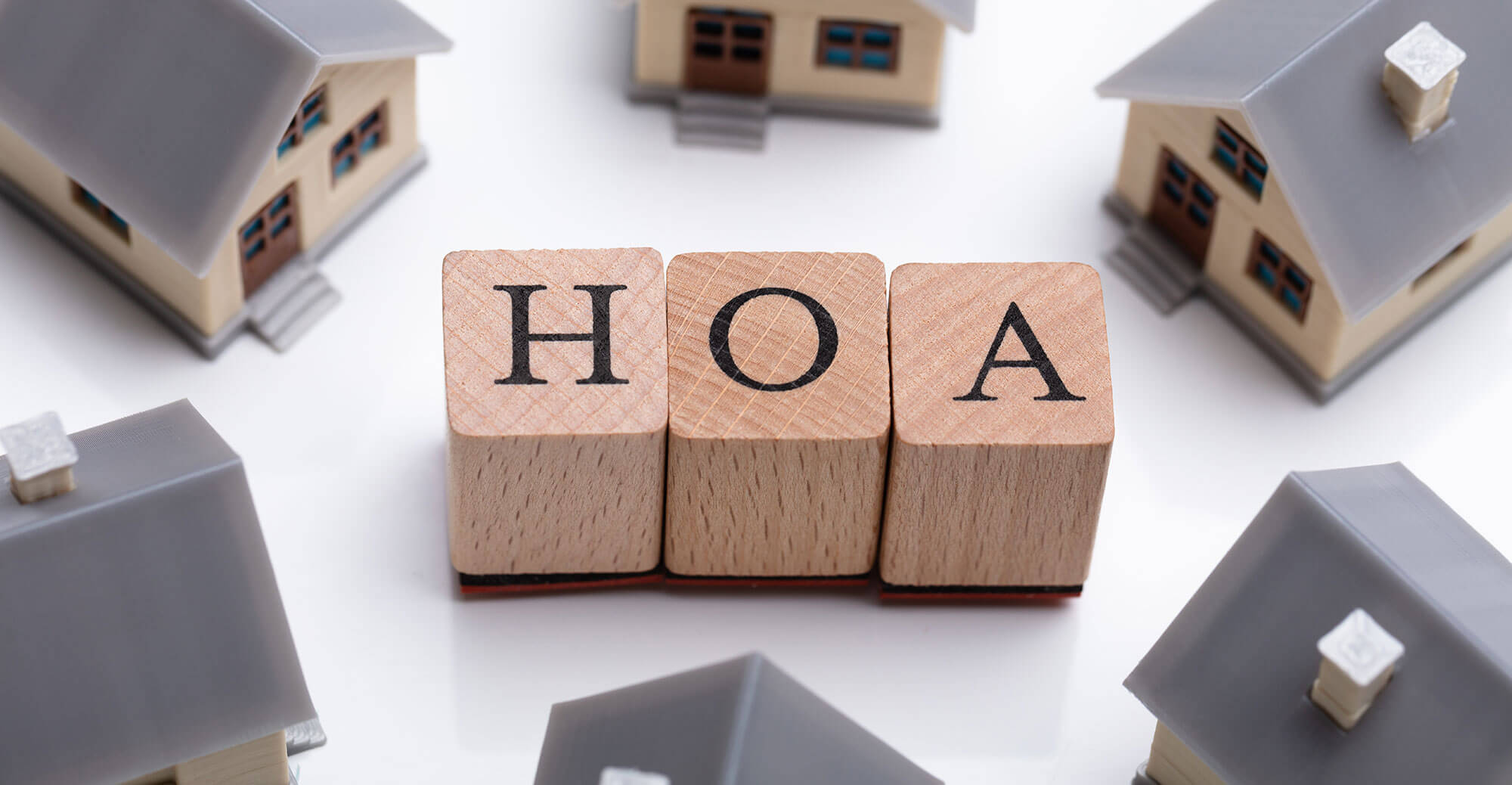 Wooden blocks spelling HOA with houses