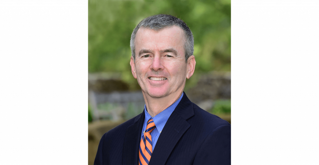 Man in suit with orange tie