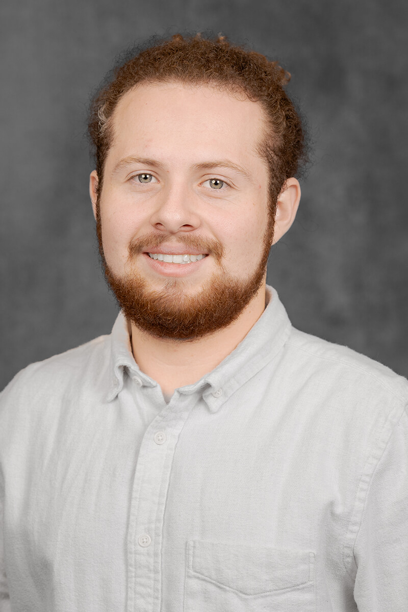 Person with curly hair, neutral background.
