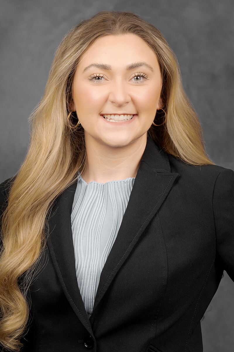 Person in professional attire, long hair.