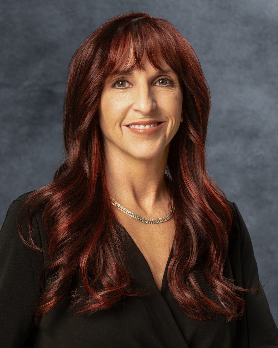 Woman with long, wavy red hair.