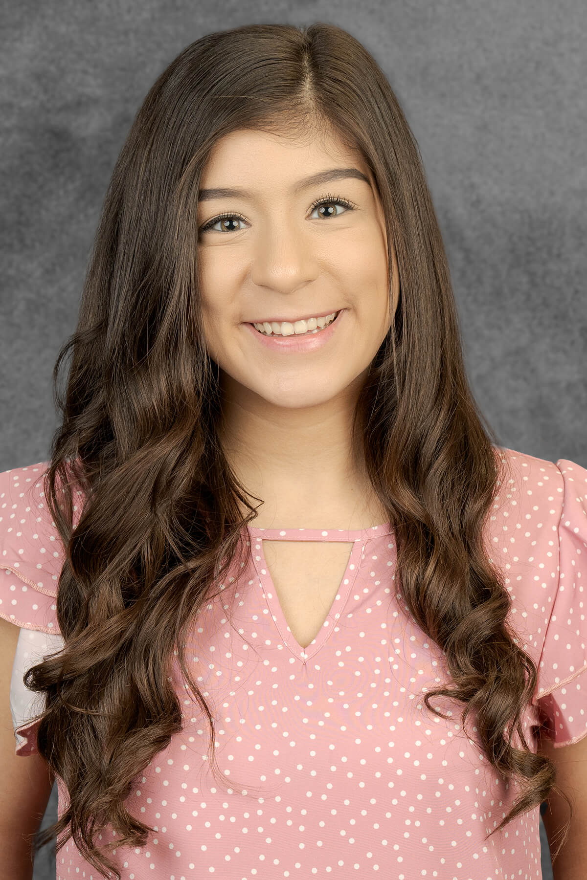 Young girl with long, wavy hair.